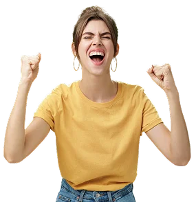Excited young woman in a yellow t-shirt raising fists and celebrating success with an energetic facial expression against a dark background.